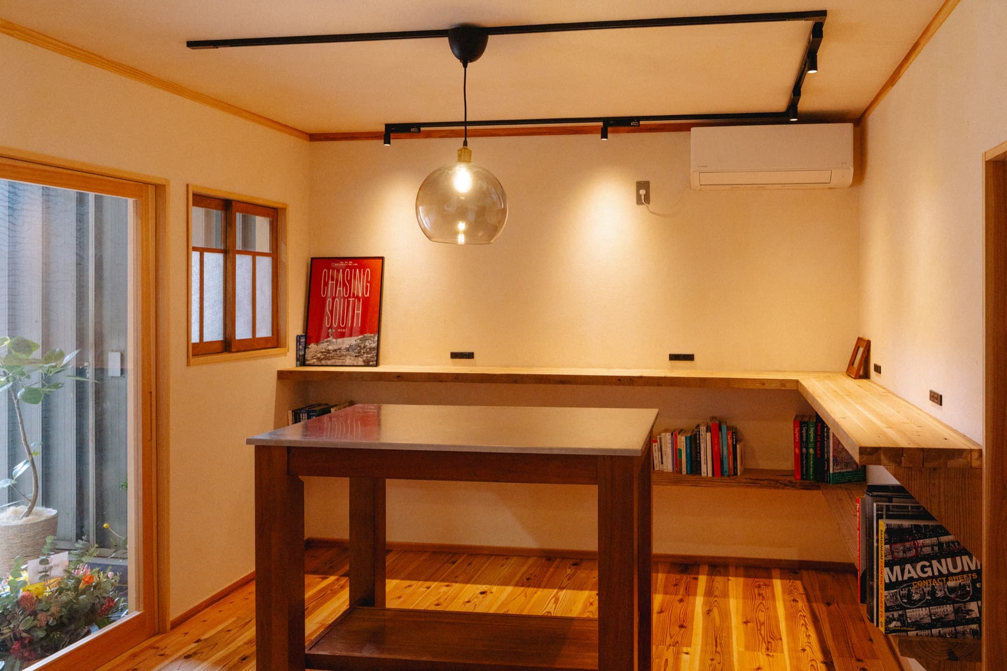 Lounge area with pendant light and bookshelf